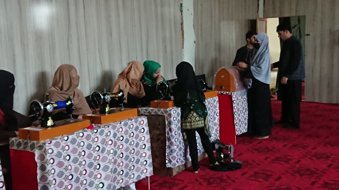 Women learning sewing and tailoring skills in Afshar